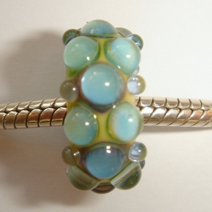 Ivory with shiny blueish green silver glass dots