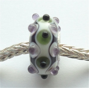 Ivory with green, purple and black dots