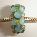 Ivory with shiny blueish green silver glass dots 